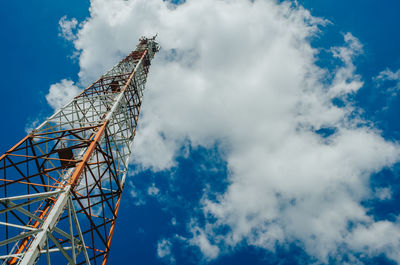 Metal tower for mobile radio communication on background of blue sky