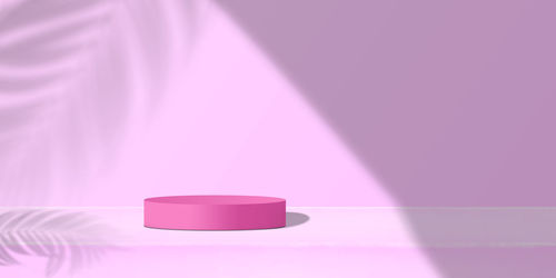 Close-up of illuminated light bulb against pink background