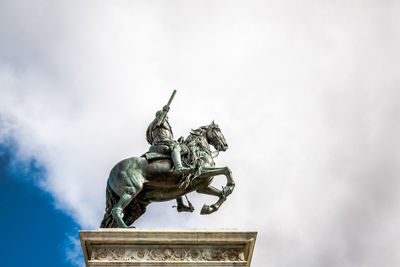 Low angle view of statue against sky