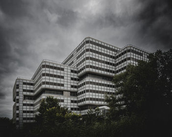 Low angle view of ibm nederland building by lucas and niemeijer against sky