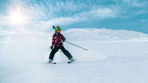 Cute child skiing down the slope