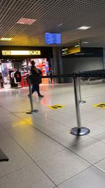 People walking on railroad station platform