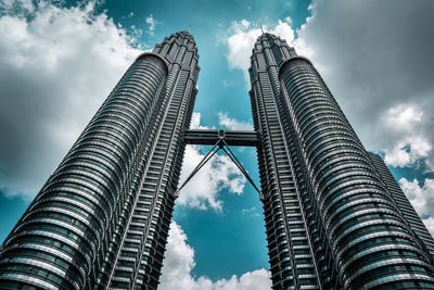 Low angle view of buildings against cloudy sky