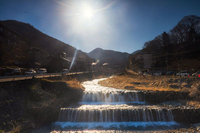 Scenic view of river against sky on sunny day