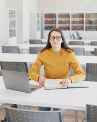 Young woman using laptop at office