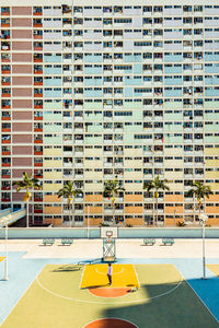 View of  basketball court gainst buildings in city