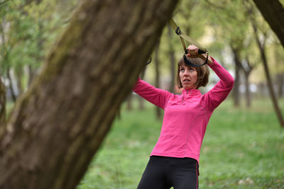 Mid adult woman exercising at public park