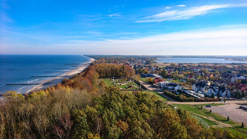 High angle view of cityscape by sea against sky