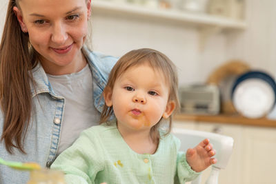 Close-up of mother and daughter at home