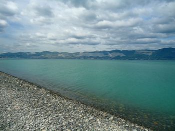 Scenic view of sea against cloudy sky