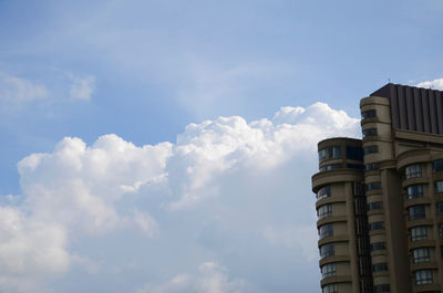 Buildings against cloudy sky