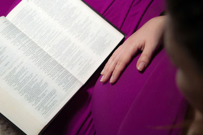 Pregnant woman with book