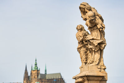 Low angle view of statue of city against sky