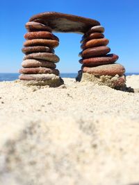 Stack of rocks on beach against clear sky