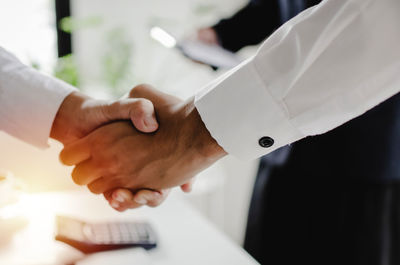 Cropped image of businessmen shaking hands