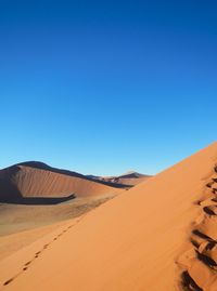 Scenic view of desert against clear sky