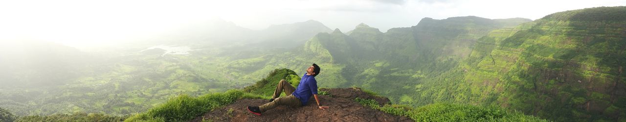 High angle view of man relaxing on mountain