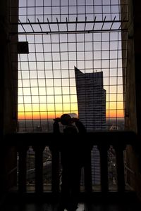 Built structures against sky at sunset