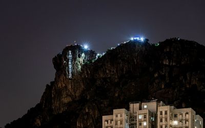 Hongkongers hike on and light up lion rock hill as human chains form with protest demands, 2019