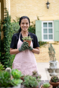 Portrait of smiling young woman standing outdoors