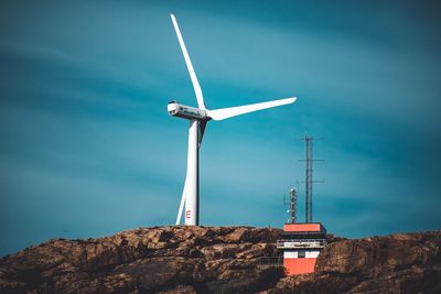 Low angle view of wind turbine against sky