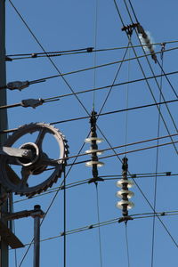 Low angle view of electricity pylon against sky