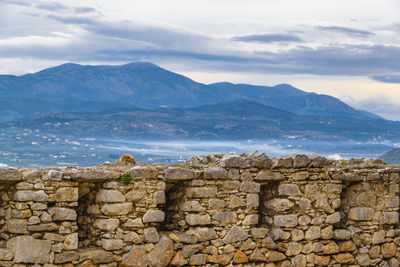 View of stone wall against cloudy sky