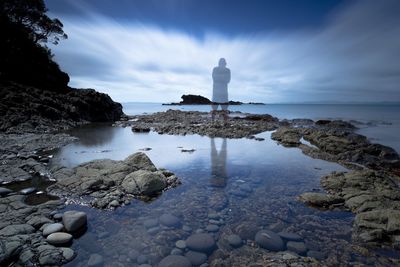 Scenic view of sea against cloudy sky