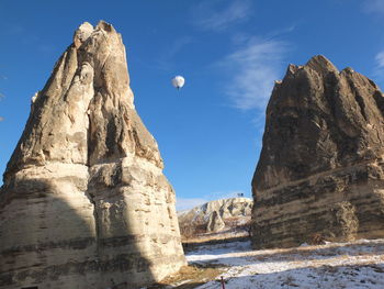 Low angle view of rock formation against sky