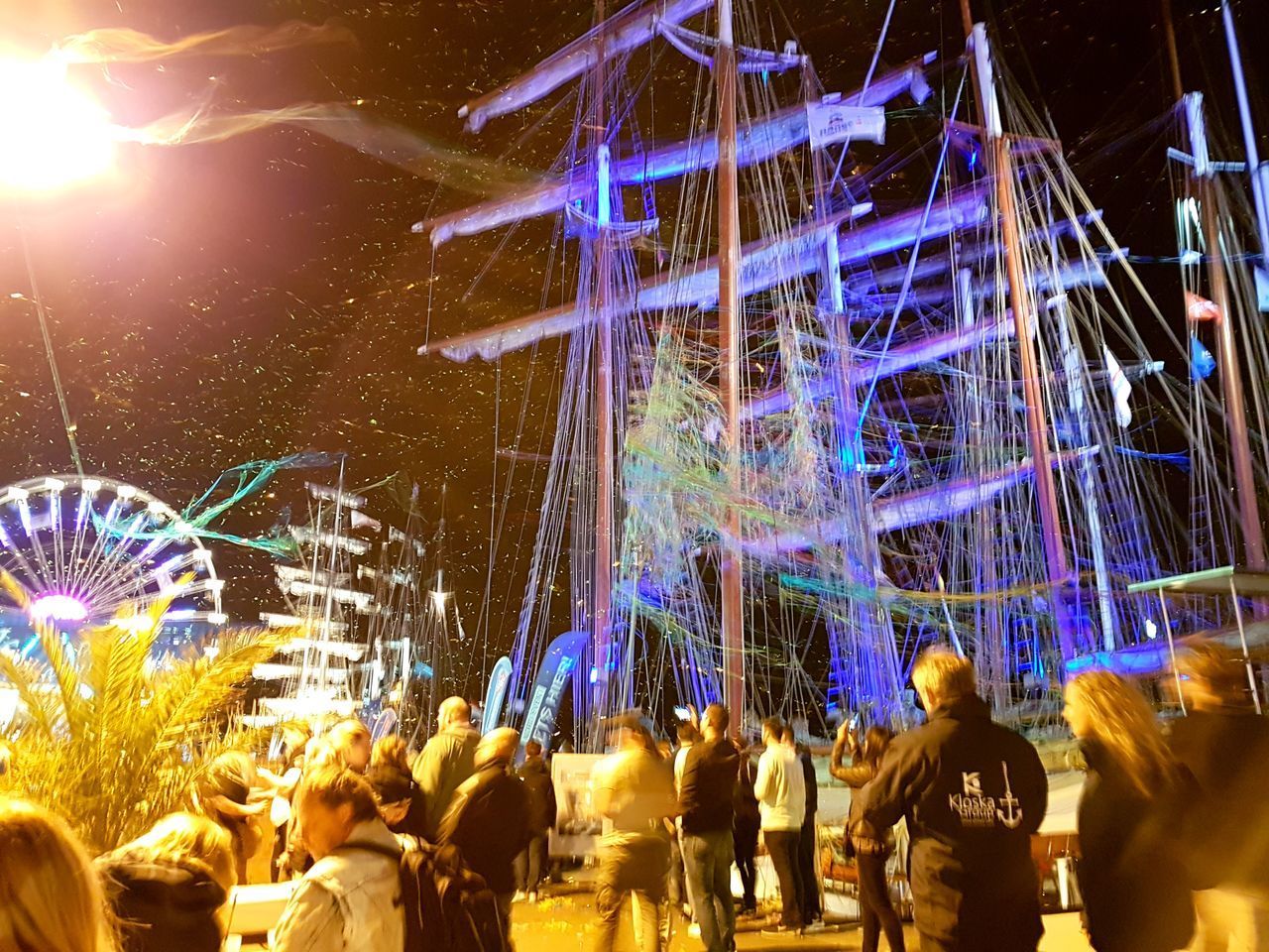 CROWD AT ILLUMINATED AMUSEMENT PARK