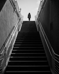 Low angle view of man walking on stairs