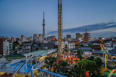 Illuminated cityscape against sky