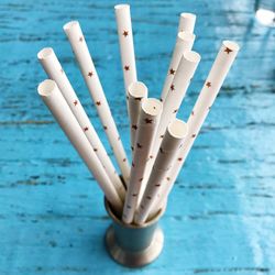 High angle view of white drinking straws in container on wooden table