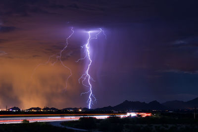 Lightning in sky over city at night
