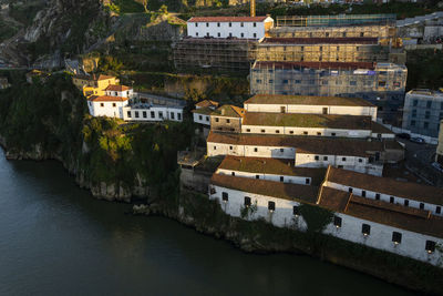 High angle view of townscape by river in city