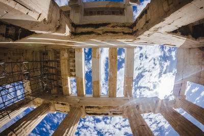 Directly below shot of acropolis of athens against cloudy sky