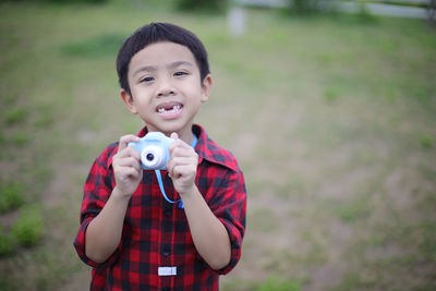 Portrait of boy standing outdoors