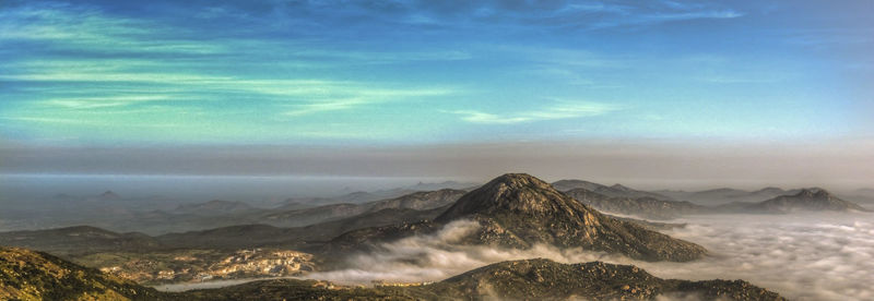 View of mountain range against cloudy sky