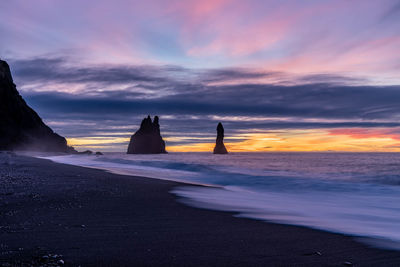 Scenic view of sea against sky during sunset at reynisdrangar, iceland