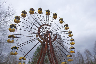 Low angle view of ferris wheel against sky