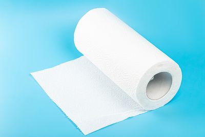 Close-up of toilet paper against blue background