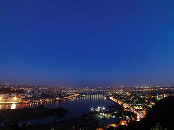 High angle view of illuminated buildings against sky at night