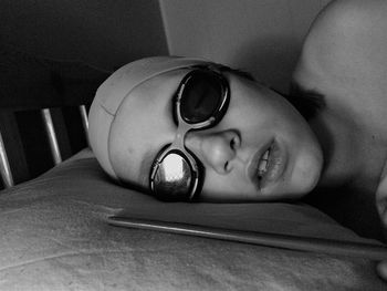 Close-up portrait of boy lying on bed