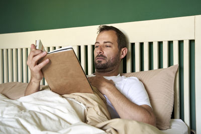 Portrait of man lying on bed