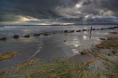 Scenic view of sea against cloudy sky