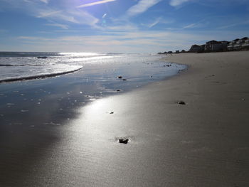 Scenic view of shore at beach against sky