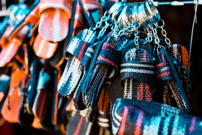 Close-up of multi slippers shaped key rings hanging for sale at street market