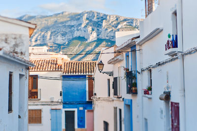 Buildings in town against sky