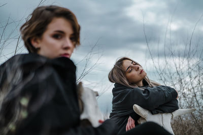 Portrait of a girl looking away against sky