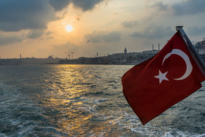 Turkish waving flag form a ferry cruising the bosphours with istanbul skyline, turkey